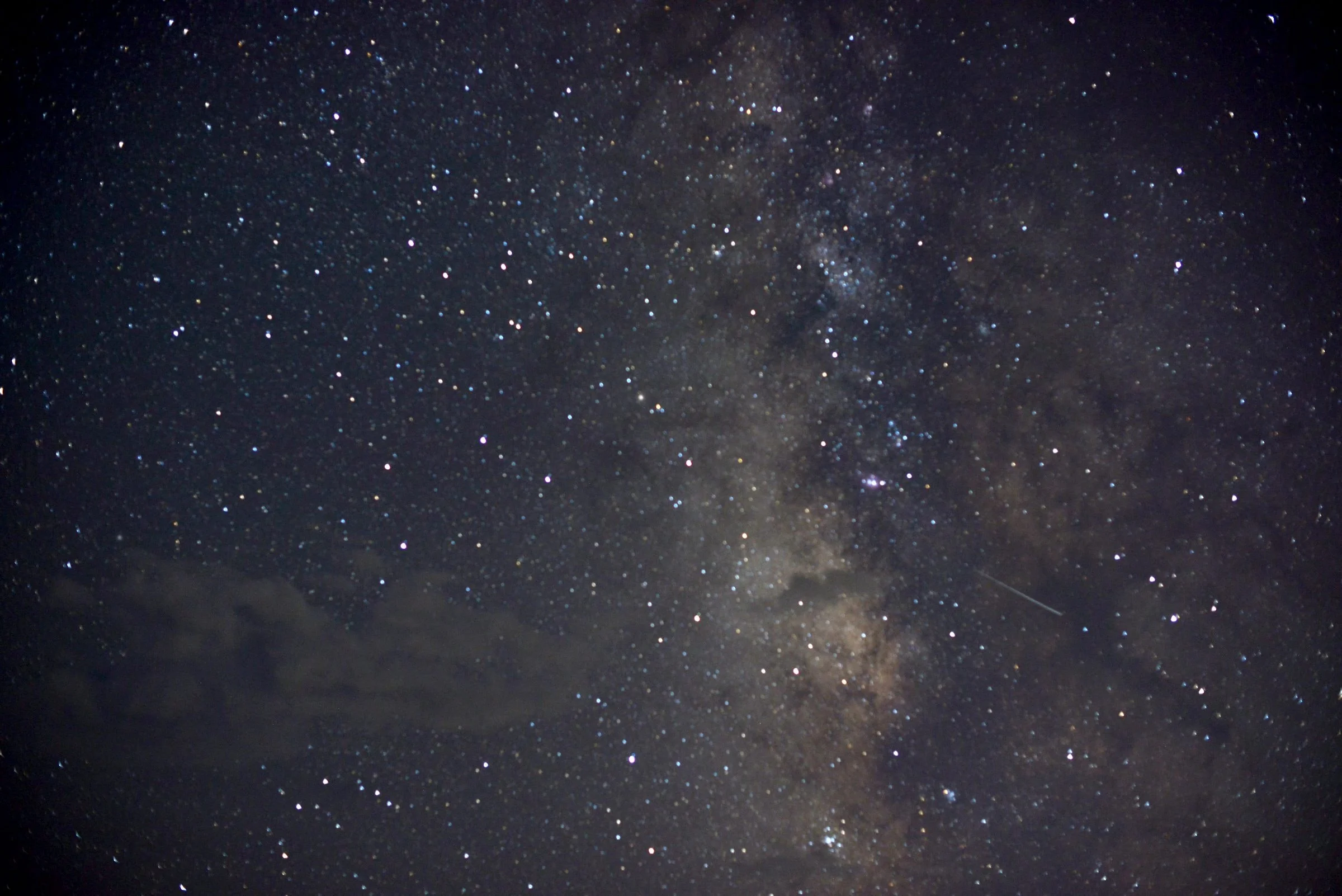 The Milky Way band and a shooting star over Liberty Farms